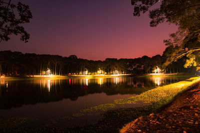 Scenic view of lake against sky at night