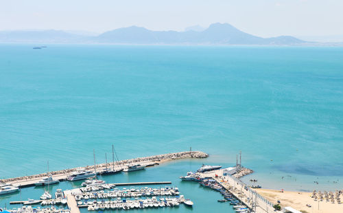 High angle view of harbor by sea against sky