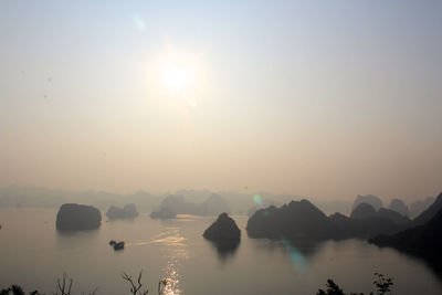 Scenic view of halong bay by rock formations against clear sky