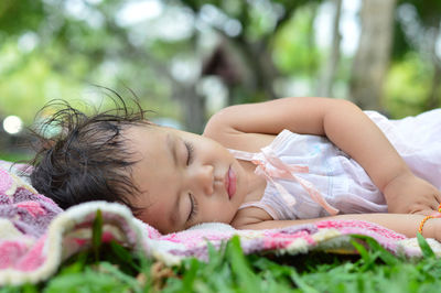 Portrait of woman sleeping on bed