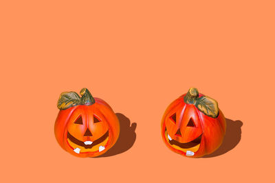 Close-up of pumpkin against orange background