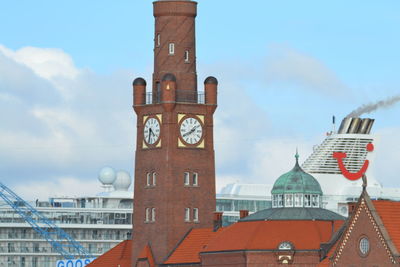 Clock tower amidst buildings in city