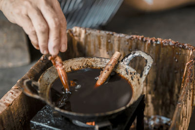 Close-up of person preparing food on metal