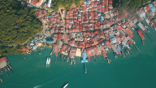 High angle view of buildings by sea