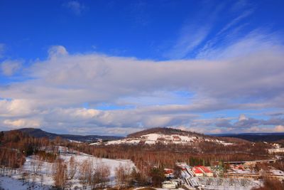 Scenic view of snowcapped mountains against blue sky