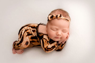 High angle view of cute baby girl on table