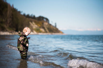 Close-up of person in sea against sky