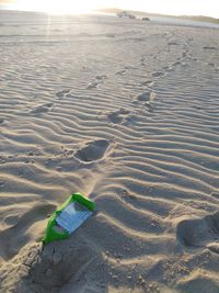 High angle view of footprints on sand at beach