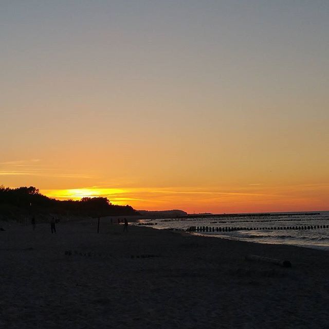 sunset, sea, beach, horizon over water, scenics, tranquil scene, orange color, tranquility, beauty in nature, water, shore, sand, idyllic, nature, sky, copy space, remote, non-urban scene, vacations, coastline