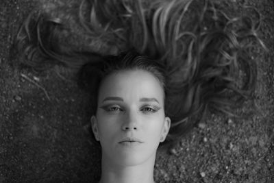 Portrait of young woman with dreamy look lying down