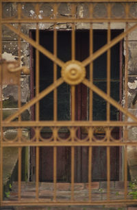 Close-up of fence against window