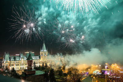 Firework display in city at night