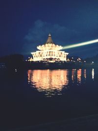 Illuminated building against sky at night