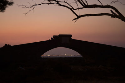 Silhouette bridge against sky during sunset