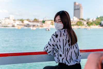 Portrait of woman against sea