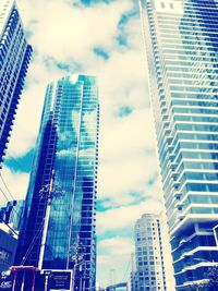 Low angle view of modern building against cloudy sky