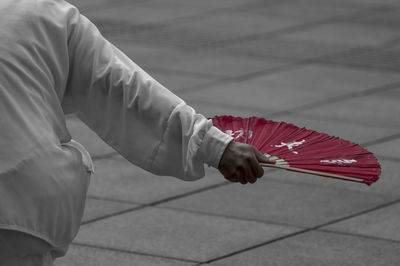 Low section of person sitting on footpath