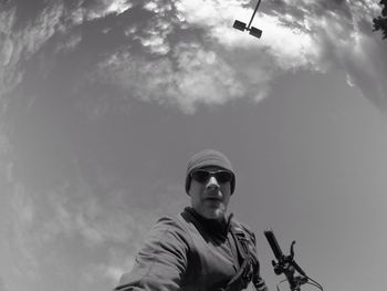 Low angle view of cyclist against sky