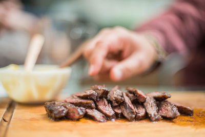 Close-up of person preparing food on table