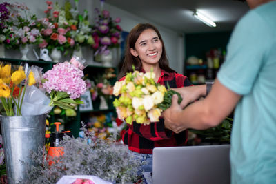 Man holding bouquet in flower shop