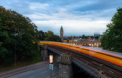 Light trails on road against sky in city