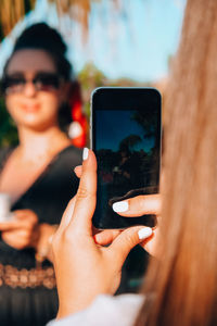 Midsection of woman using mobile phone