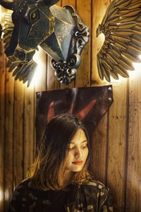 Young woman looking down while sitting at restaurant