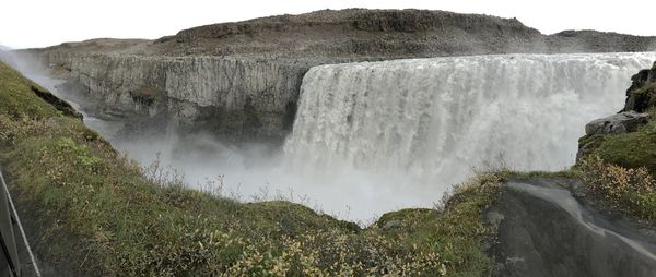 Scenic view of waterfall against rocks