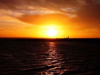 Scenic view of sea against romantic sky at sunset