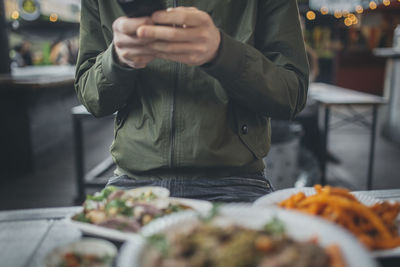 Person using cell phone in restaurant