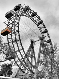 Low angle view of ferris wheel against sky