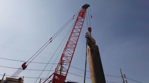 Low angle view of crane against sky
