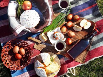 Family picnic with easter cakes, wine and eggs.easter feeding on the grass on the lawn in nature.