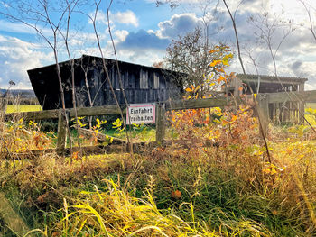 Abandoned built structure on field against sky