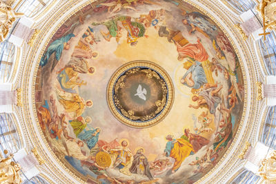 Directly below shot of ornate ceiling in building