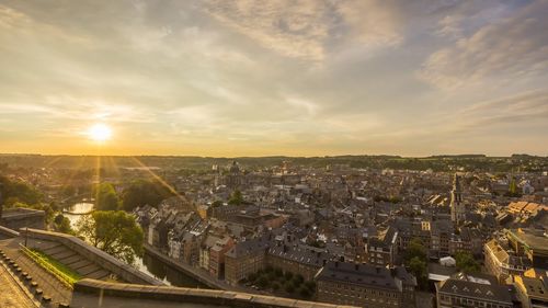 High angle view of city buildings against sky during sunset