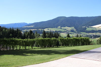 Scenic view of landscape and mountains against clear sky