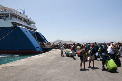 Group of people in boat against clear sky