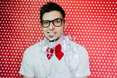 Portrait of young man wearing mask against gray background