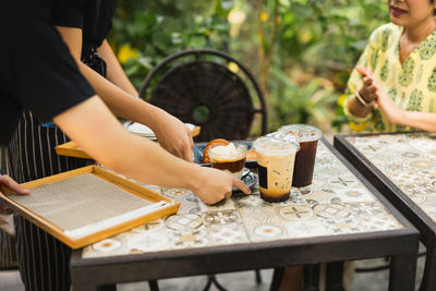 Midsection of woman using laptop at table