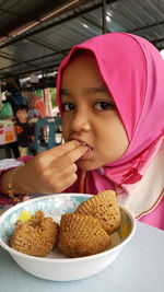 Portrait of cute girl eating food