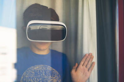 Teenage boy wearing virtual reality simulator