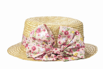 Close-up of pink hat on rock against white background