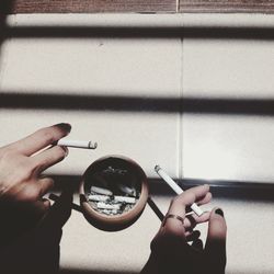 Hands holding cigarettes 