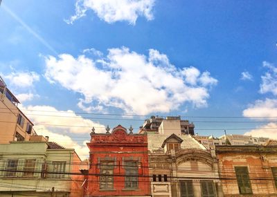 Low angle view of buildings against blue sky