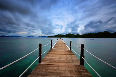 Pier over lake against sky