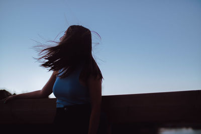 Rear view of woman against sky