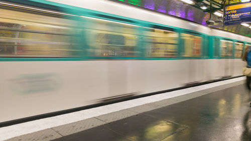 Blurred motion of train at railroad station