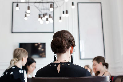 Side view of woman using laptop at home