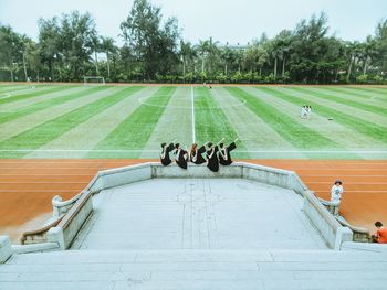 High angle view of graduation celebration at stadium